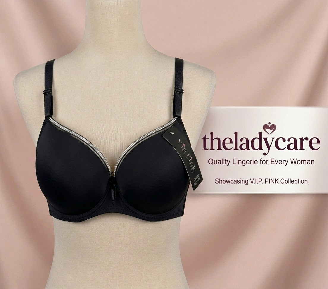 t-shirt bra featuring silver accent trim along the top of the cups, adjustable shoulder straps, and a small decorative bow at the center. It is displayed on a neutral female mannequin torso.