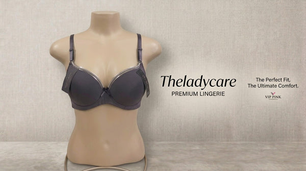 t-shirt bra featuring silver accent trim along the top of the cups, adjustable shoulder straps, and a small decorative bow at the center. It is displayed on a neutral female mannequin torso.